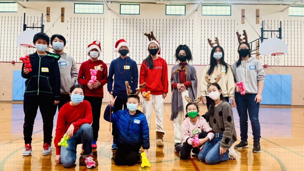 Students in Christmas attire gather for a group photo.