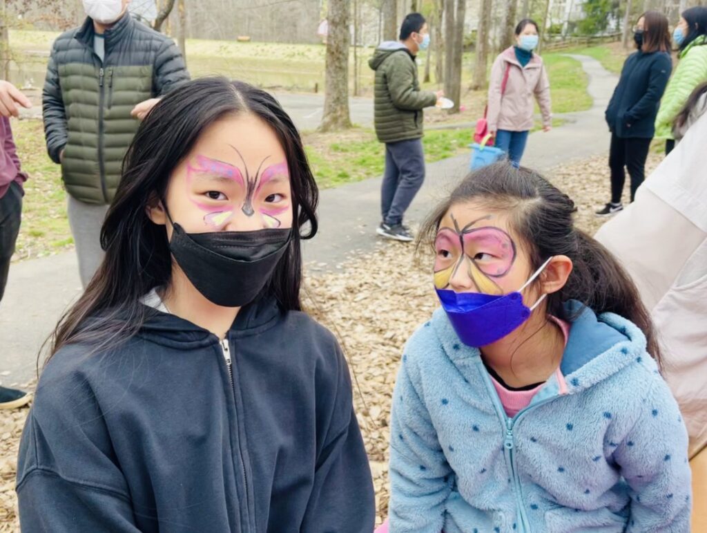 Students show off their butterfly face paint.